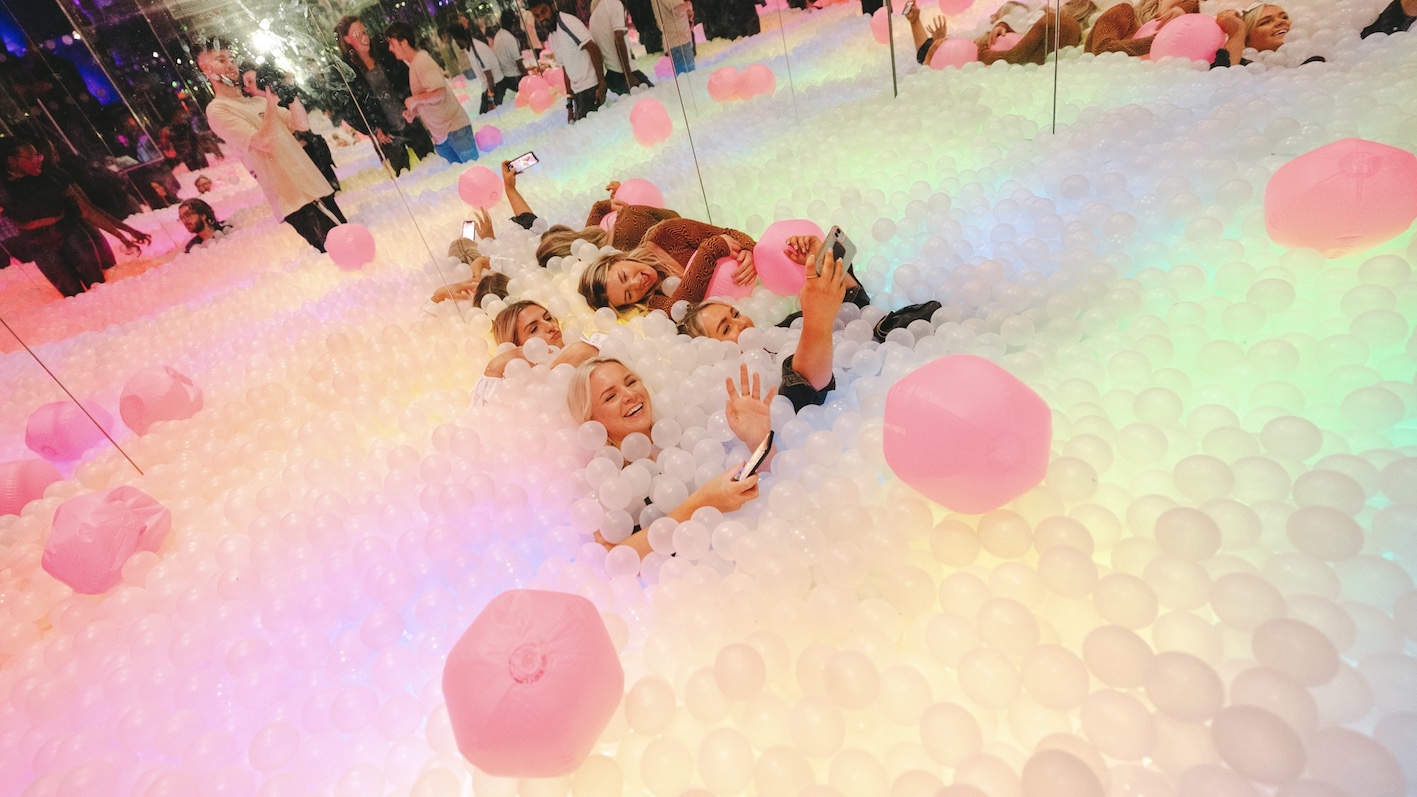 a group of girls playing in a ball pit