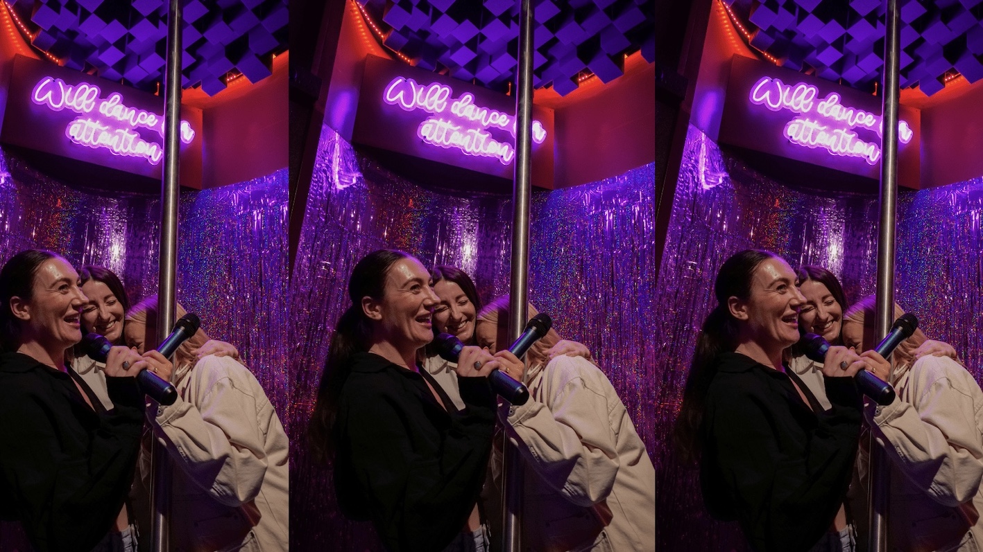 three girls singing in a karaoke booth